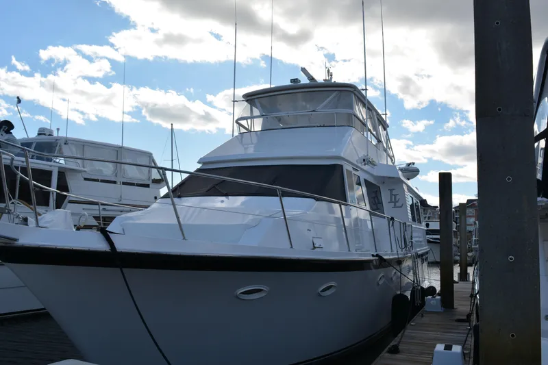 Slide: The Image of 1989 Viking Motor Yacht docked under a partly cloudy sky. - 3