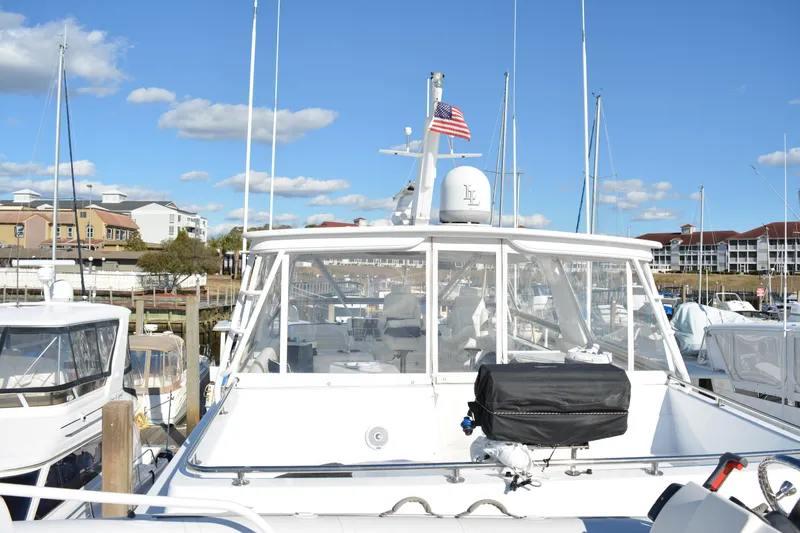 Slide: The Image of 1989 Viking Motor Yacht docked at marina under blue sky. - 30