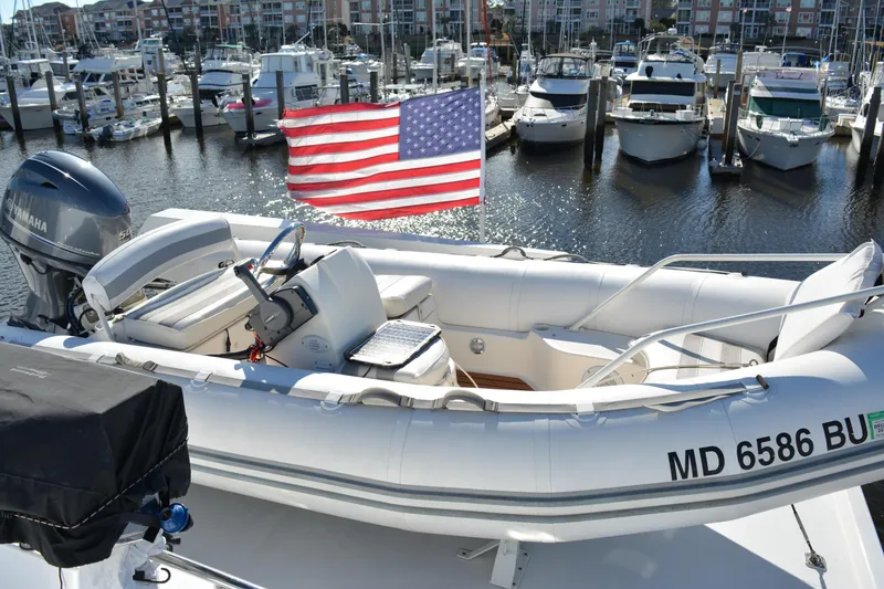 Slide: The Image of 1989 Viking Motor Yacht docked with American flag, surrounded by other boats in marina. - 31
