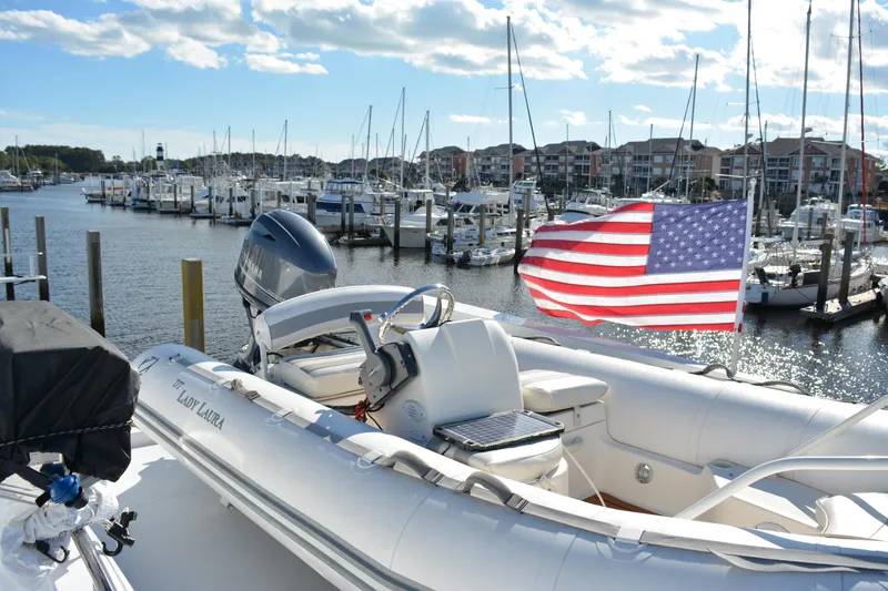 Slide: The Image of 1989 Viking Motor Yacht docked with American flag, marina background. - 32