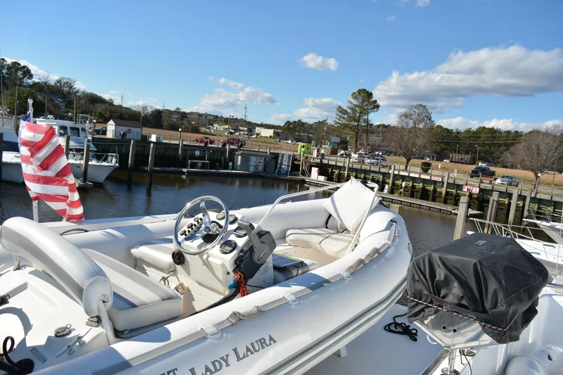 Slide: The Image of 1989 Viking Motor Yacht docked, featuring a spacious deck and American flag. - 34