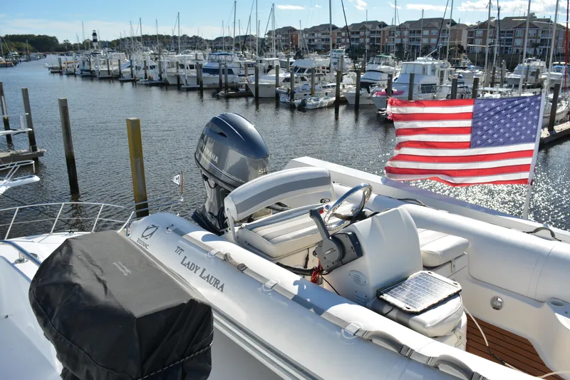 Slide: The Image of 1989 Viking Motor Yacht docked in marina with American flag, surrounded by other boats. - 35