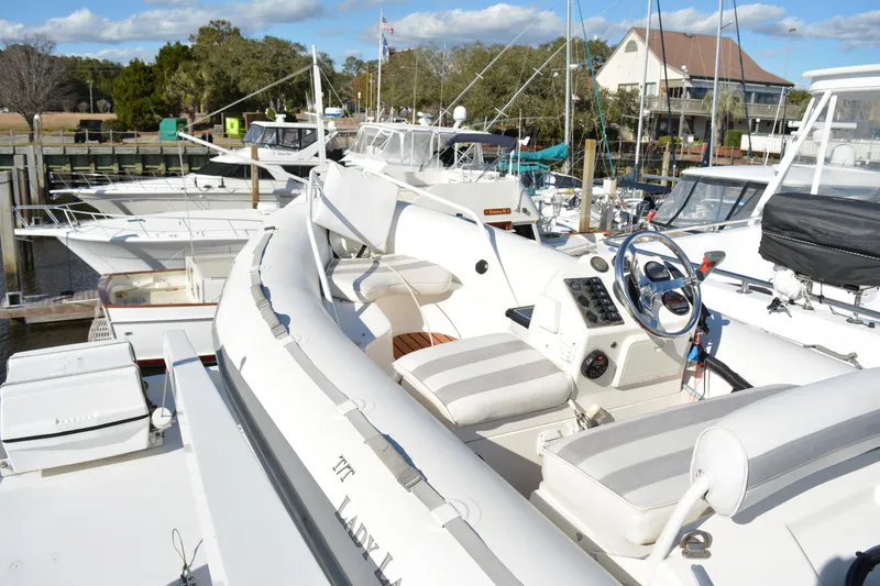 Slide: The Image of 1989 Viking Motor Yacht docked at marina, featuring spacious deck and steering console. - 37