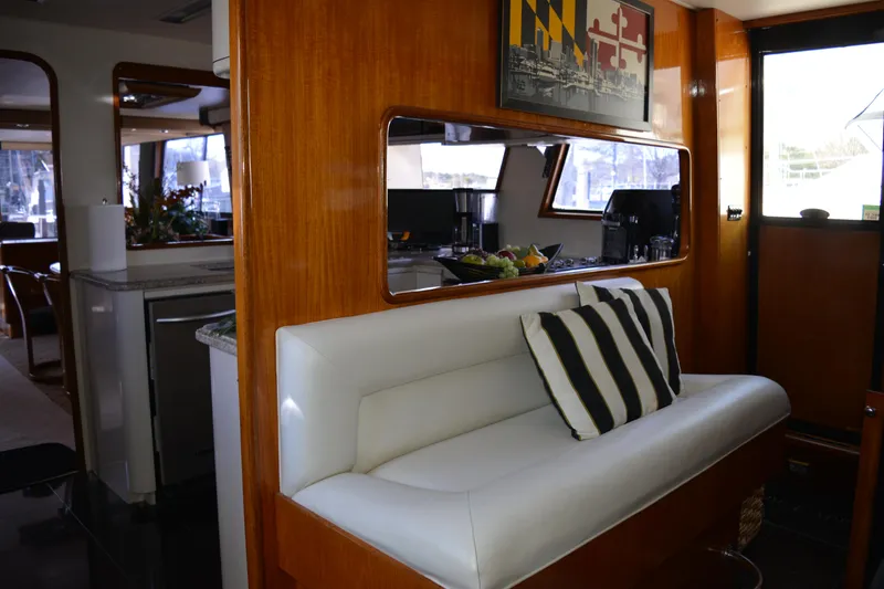 Slide: The Image of Interior of 1989 Viking Motor Yacht with white seating and striped pillow. - 39