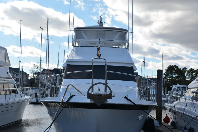 Slide: The Image of 1989 Viking Motor Yacht docked at marina under cloudy sky. - 4