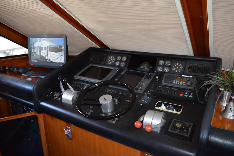 Slide: The Image of Control panel of a 1989 Viking Motor Yacht with steering wheel and navigation equipment. - 40