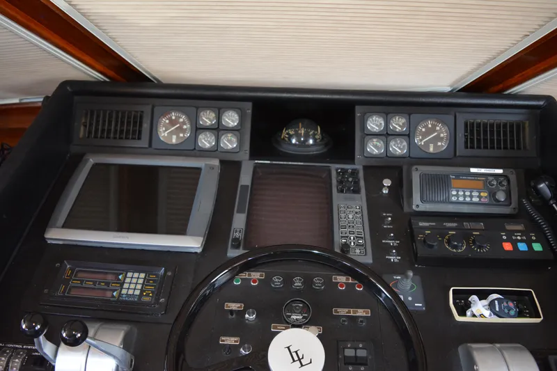Slide: The Image of Control panel of a 1989 Viking Motor Yacht with navigation instruments and gauges. - 42