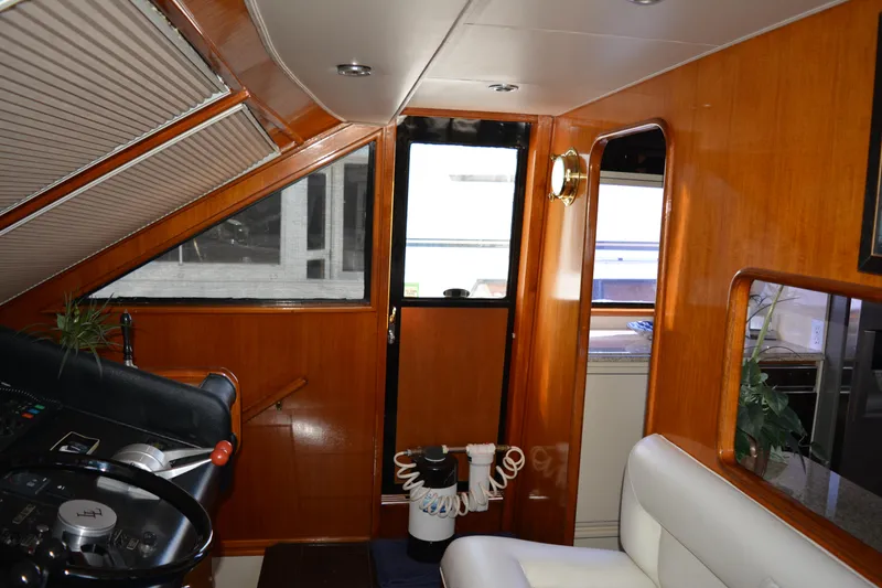Slide: The Image of Interior of 1989 Viking Motor Yacht with wooden paneling and steering wheel. - 44