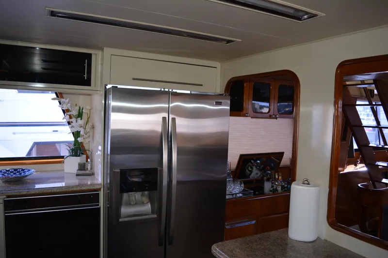 Slide: The Image of Interior of 1989 Viking Motor Yacht kitchen with stainless steel appliances and wooden cabinetry. - 49