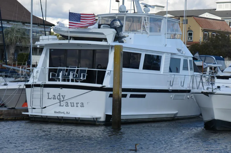 Slide: The Image of 1989 Viking motor yacht "Lady Laura" docked, displaying an American flag. - 5