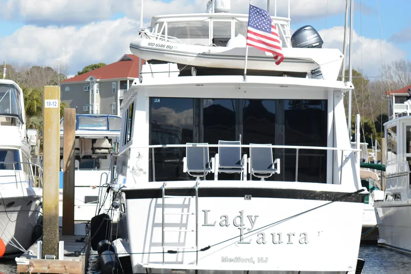 Slide: The Image of 1989 Viking motor yacht "Lady Laura" docked with American flag. - 6