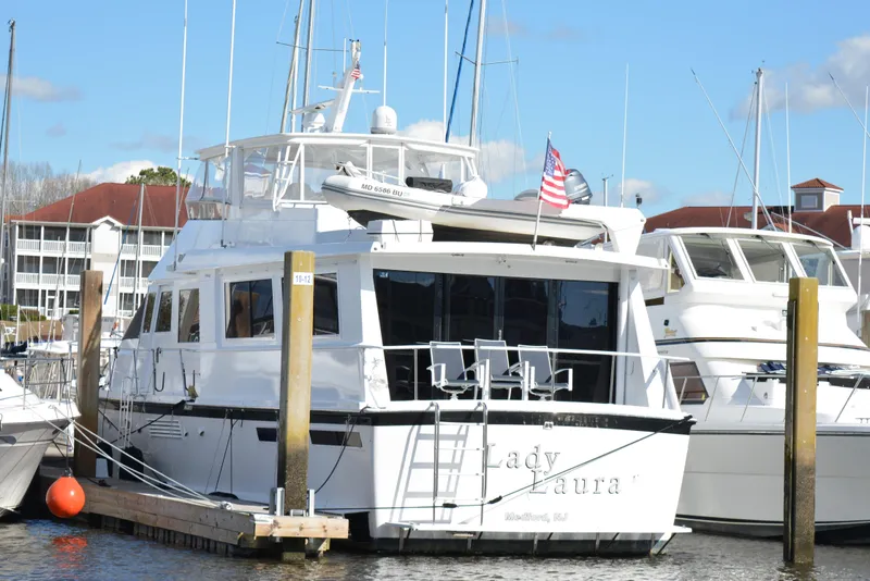 Slide: The Image of 1989 Viking Motor Yacht docked at marina with American flag. - 8