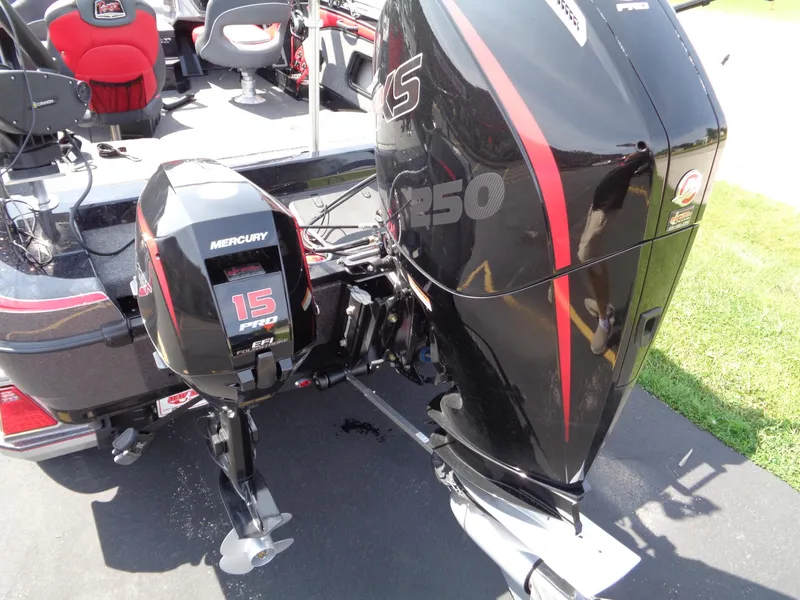 Slide: The Image of 2023 Ranger 2080MS boat with Mercury 15 and 250 engines, parked on pavement. - 23