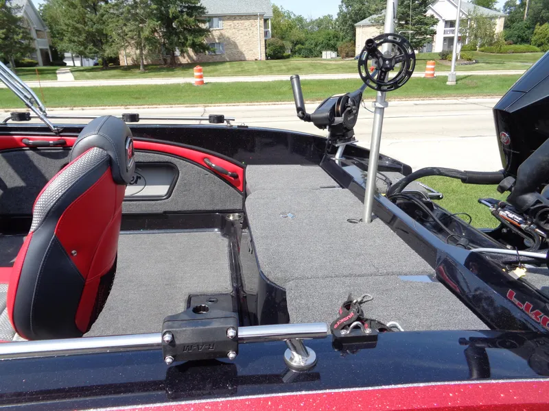 Slide: The Image of 2023 Ranger 2080MS A Pack boat interior with red seats and fishing equipment. - 6