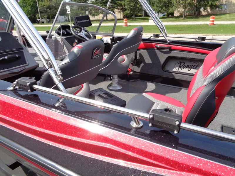Slide: The Image of 2023 Ranger 2080MS A Pack boat interior with red and black seating, steering console, and chrome details. - 7