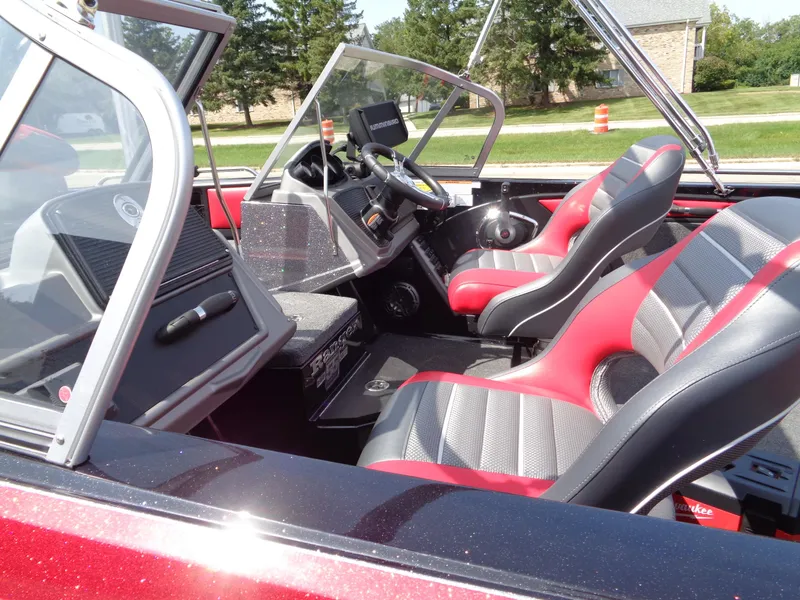 Slide: The Image of 2023 Ranger 2080MS A Pack boat interior with red and gray seats. - 8