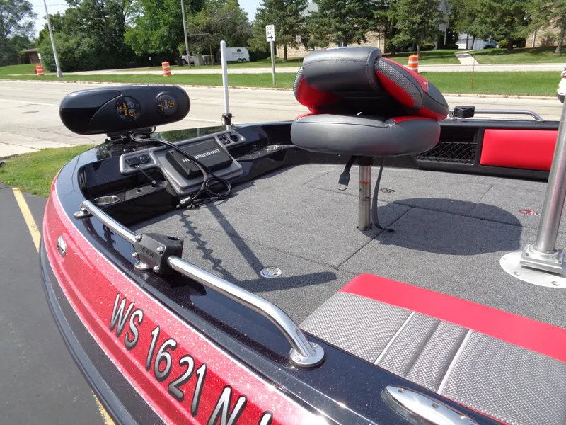 Slide: The Image of 2023 Ranger 2080MS A Pack boat interior with red and gray seating, equipped for fishing. - 9