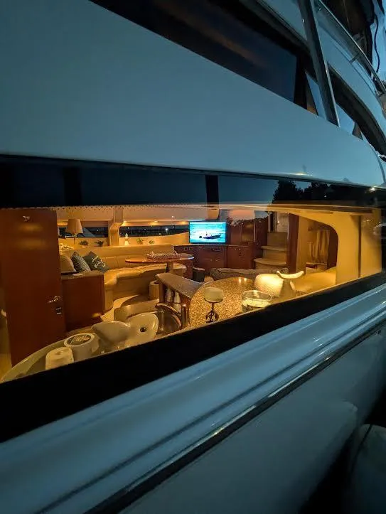 Slide: The Image of Interior view of a 2005 Meridian 459 Motoryacht through a window, showcasing luxurious furnishings. - 16