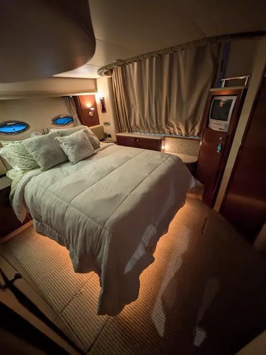 Slide: The Image of Luxurious bedroom interior of 2005 Meridian 459 Motoryacht with cozy bedding and ambient lighting. - 20