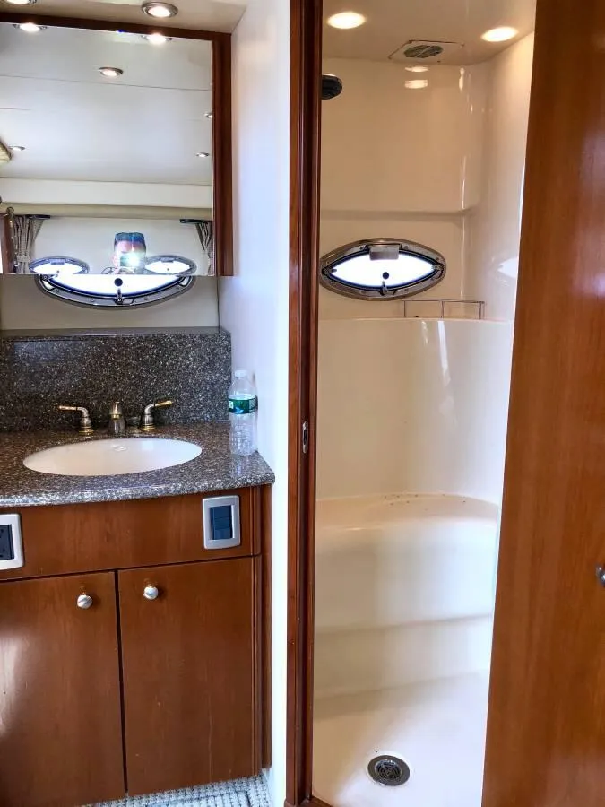 Slide: The Image of 2005 Meridian 459 Motoryacht bathroom with sink, shower, and wooden cabinetry. - 21