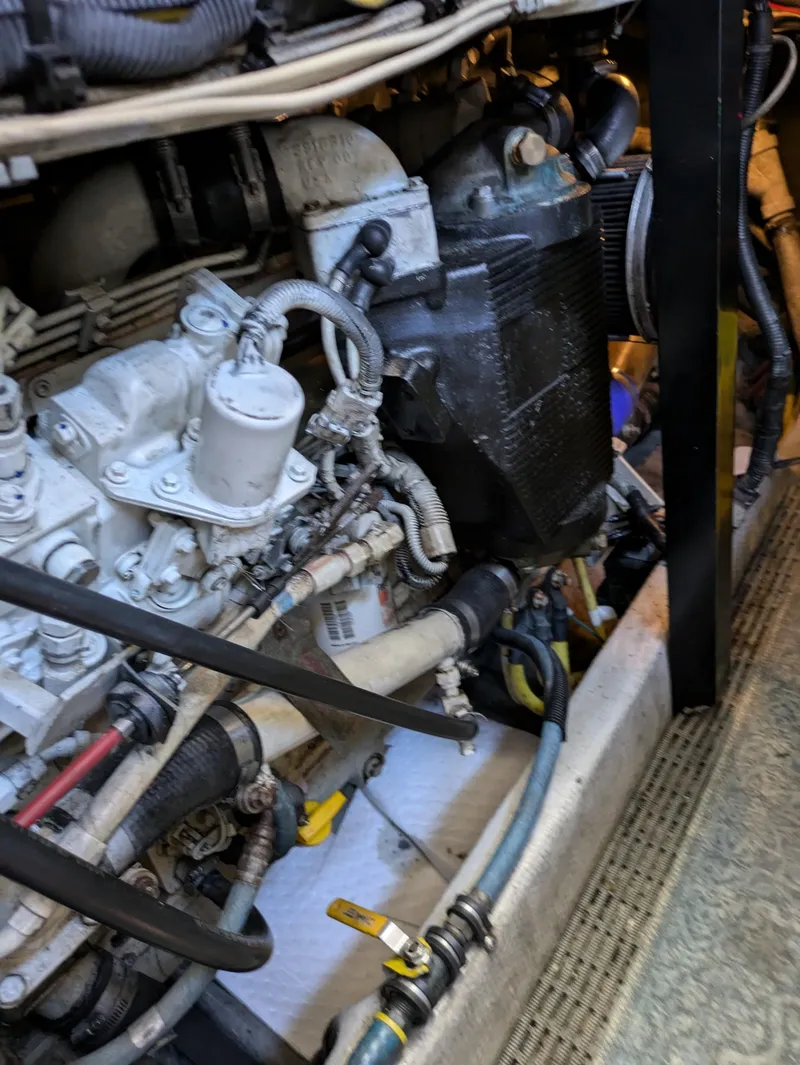 Slide: The Image of Engine compartment of a 2005 Meridian 459 Motoryacht, showcasing mechanical components and wiring. - 23