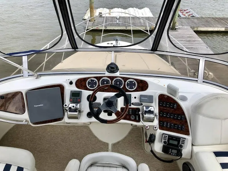 Slide: The Image of 2005 Meridian 459 Motoryacht helm with steering wheel, controls, and navigation equipment. - 8