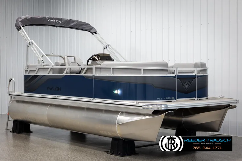 Slide: The Image of 2025 Avalon VLS QL pontoon boat with sleek design in showroom. - 2