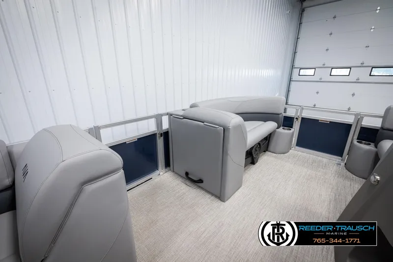 Slide: The Image of 2025 Avalon VLS QL boat interior with gray seating in a garage setting. - 20