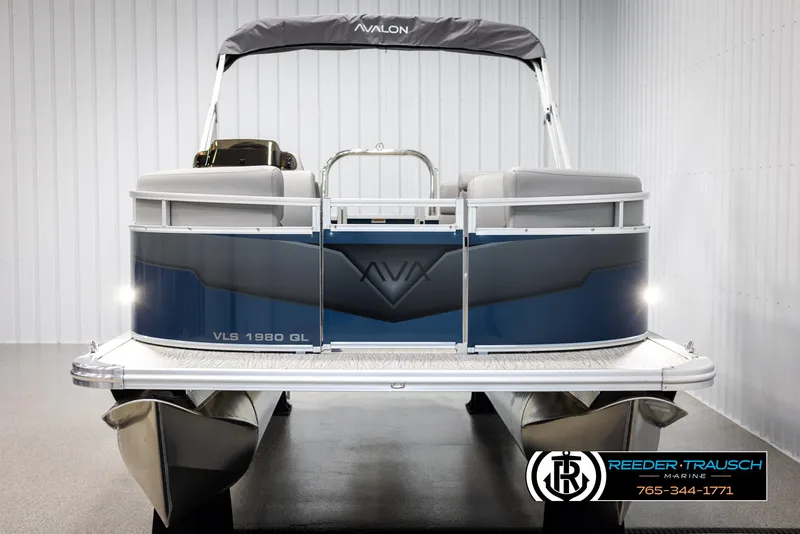 Slide: The Image of 2025 Avalon VLS QL pontoon boat in showroom, rear view, blue and gray design. - 8