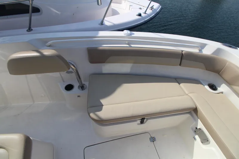 Slide: The Image of 2017 Sailfish 236 CC boat interior with beige seating and cup holder. - 10