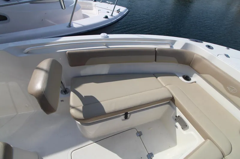 Slide: The Image of 2017 Sailfish 236 CC boat interior with beige seating and storage compartments. - 11