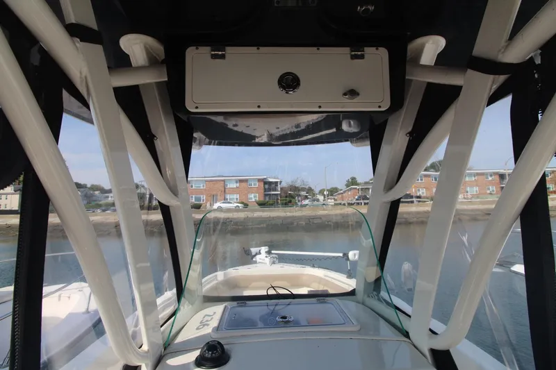 Slide: The Image of Interior view of 2017 Sailfish 236 CC boat with waterfront background. - 14
