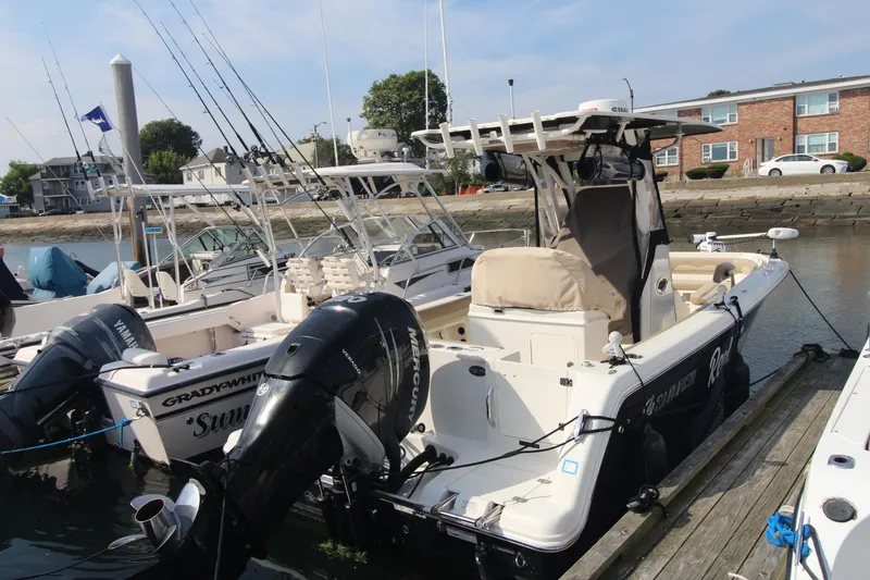 Slide: The Image of 2017 Sailfish 236 CC boat docked with twin outboard motors. - 2