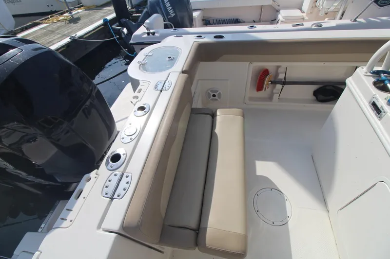 Slide: The Image of 2017 Sailfish 236 CC boat interior with seating and storage compartments. - 20
