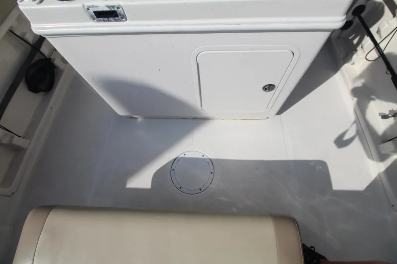 Slide: The Image of 2017 Sailfish 236 CC boat interior with storage compartment and seating. - 21