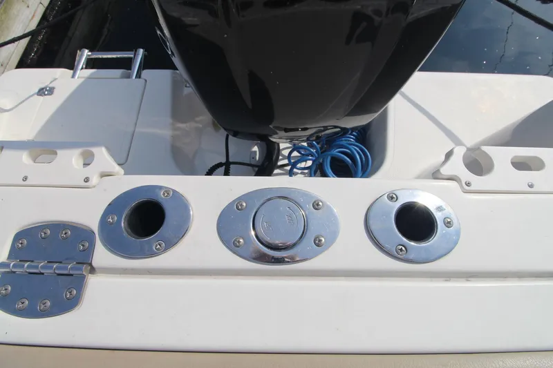 Slide: The Image of 2017 Sailfish 236 CC boat stern with rod holders and engine. - 22