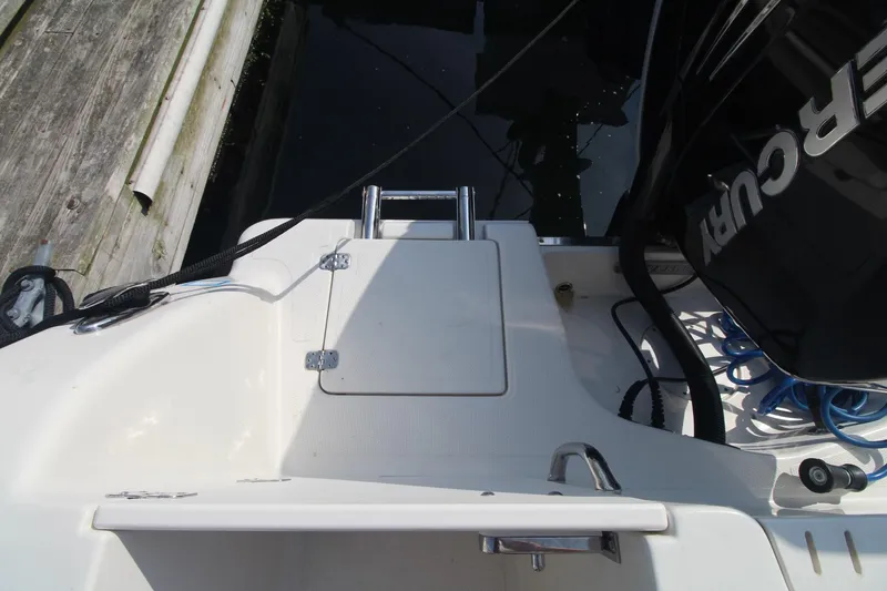 Slide: The Image of 2017 Sailfish 236 CC boat stern with Mercury engine and swim ladder. - 24