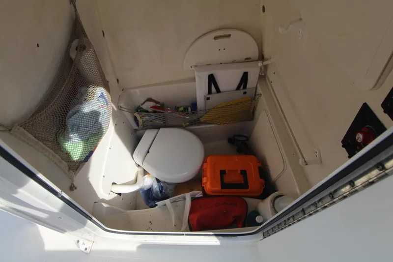 Slide: The Image of Interior of 2017 Sailfish 236 CC boat with compact toilet and storage. - 32