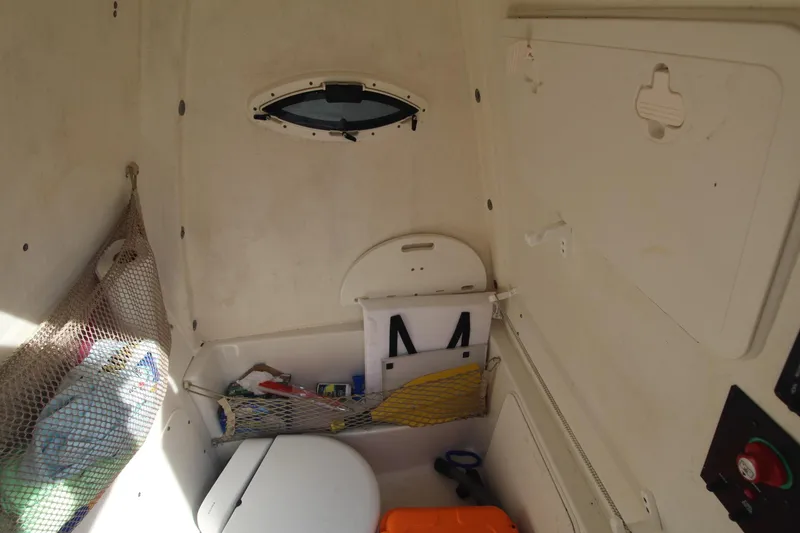 Slide: The Image of Interior of 2017 Sailfish 236 CC boat with storage and compact toilet. - 33