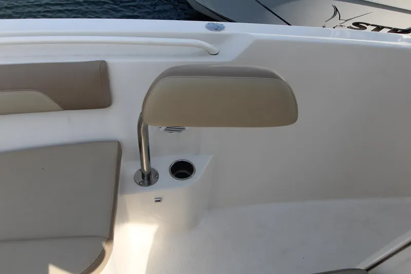 Slide: The Image of 2017 Sailfish 236 CC boat interior with beige seating and cup holder. - 7