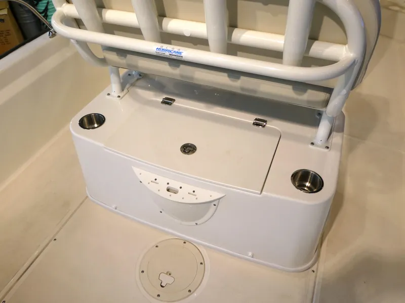 Slide: The Image of 2024 Boston Whaler 210 Montauk boat seating area with storage and cup holders. - 10