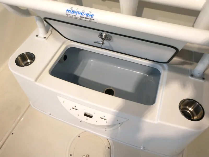 Slide: The Image of 2024 Boston Whaler 210 Montauk boat console with storage compartment and cup holders. - 11