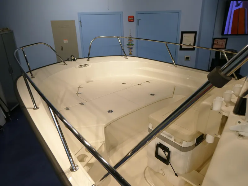 Slide: The Image of 2024 Boston Whaler 210 Montauk boat interior with spacious deck and stainless steel railings. - 4