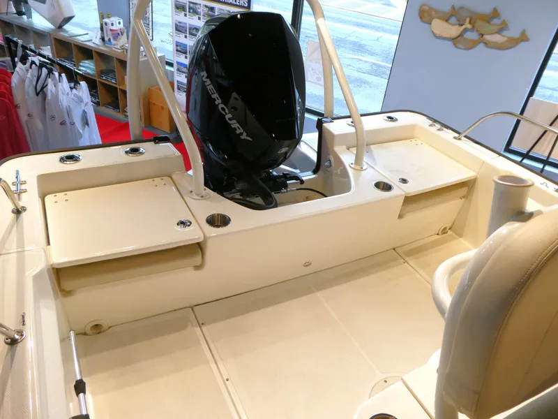 Slide: The Image of 2024 Boston Whaler 210 Montauk boat interior with Mercury engine, showroom display. - 5