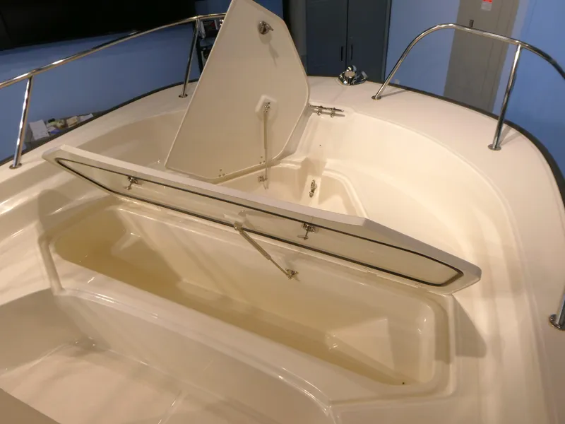 Slide: The Image of 2024 Boston Whaler 210 Montauk boat storage compartment with open hatch. - 9