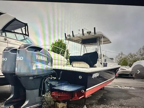 Slide: The Image of 1990 Intrepid 30 Console Cuddy boat with twin Yamaha 250 engines, docked outdoors. - 4