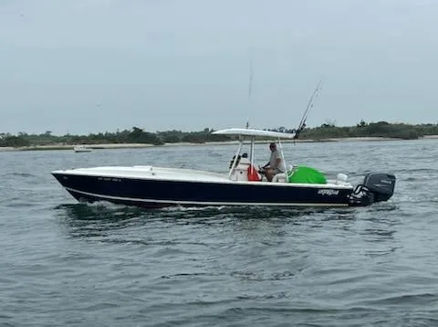 Slide: The Image of 1990 Intrepid 30 Console Cuddy boat cruising on open water. - 5