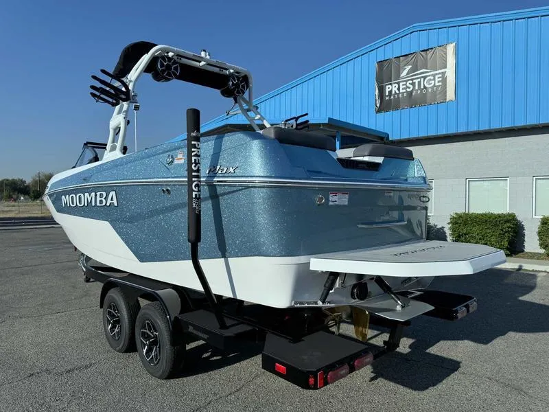 Slide: The Image of 2025 Moomba Max boat on trailer, parked outside Prestige building. - 4