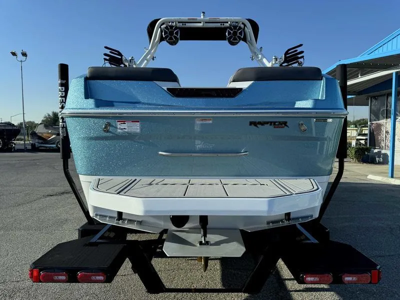 Slide: The Image of 2025 Moomba Max boat, blue exterior, rear view, parked on trailer. - 6