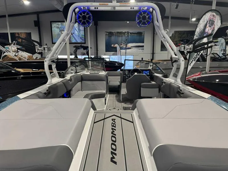 Slide: The Image of 2025 Moomba Max boat interior with spacious seating and modern design in showroom. - 8